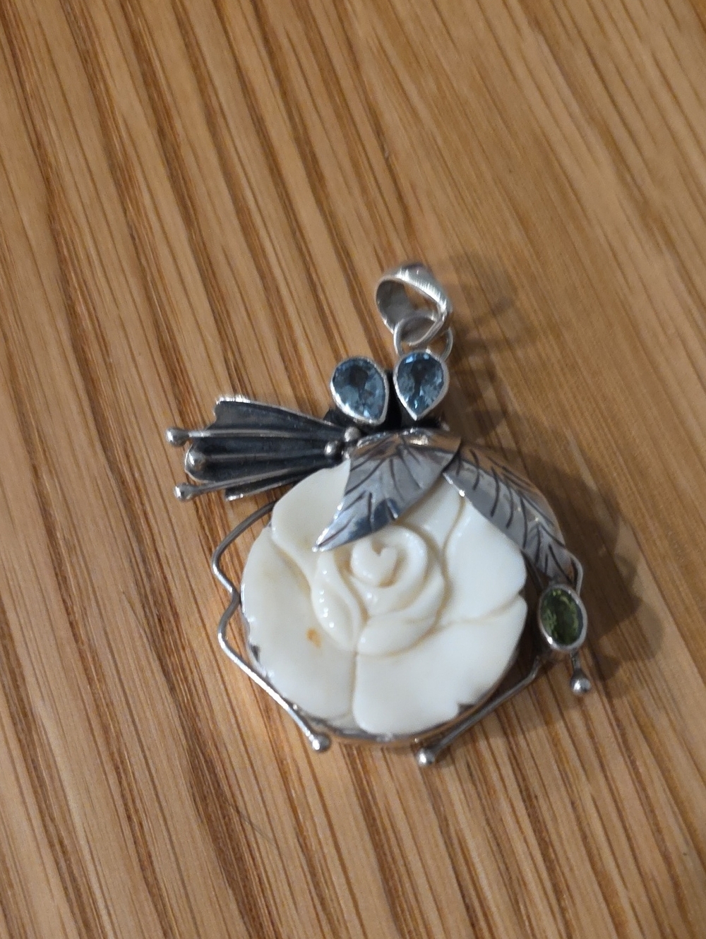 975 silver pendant features a carved Bone flower, Stones. Indonesia